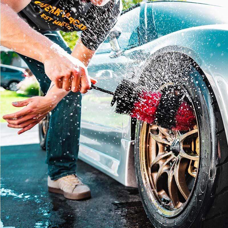 Premium Photo  Man cleans auto with car rim cleaner, carwash